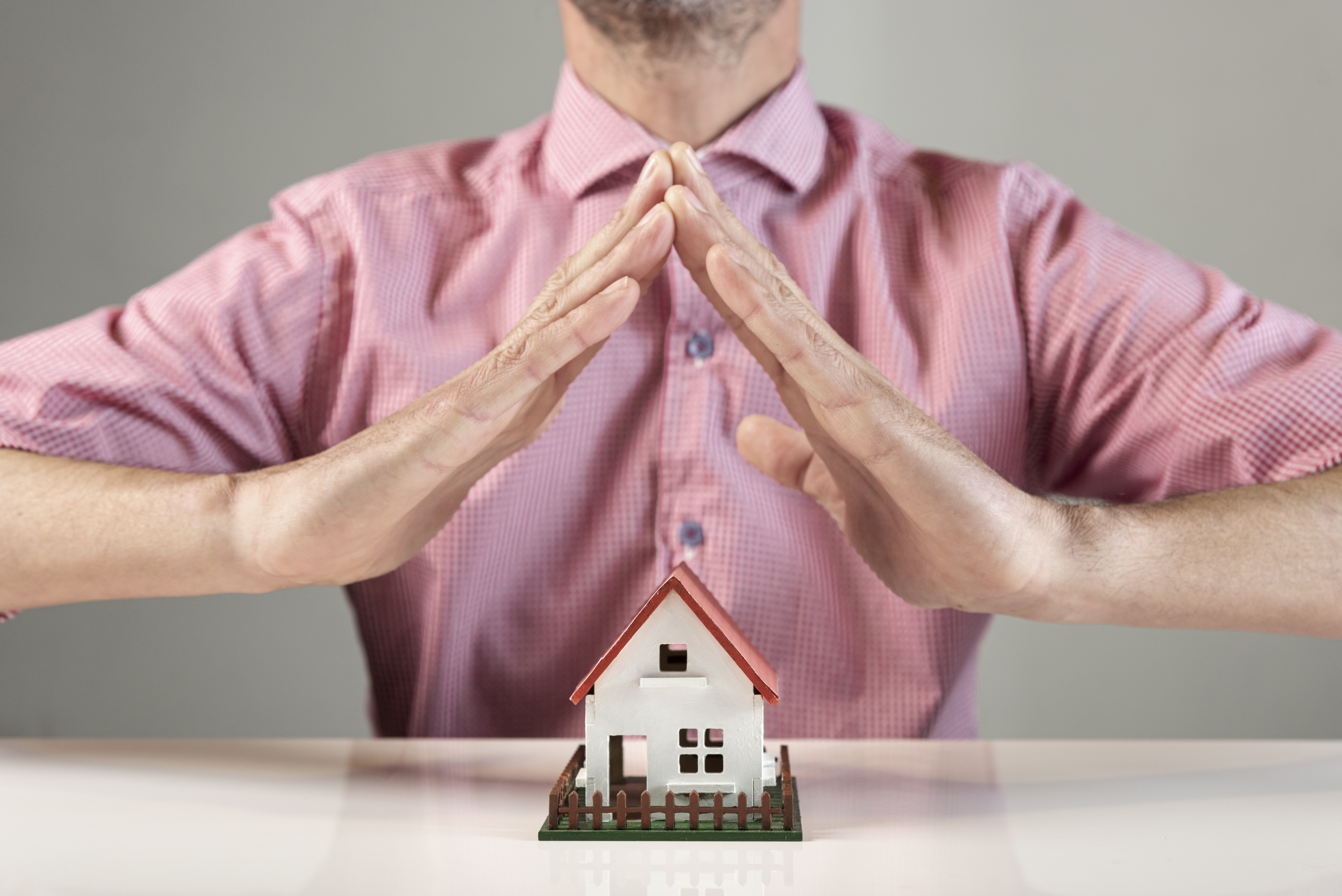 person-creating-roof-house-with-his-hands