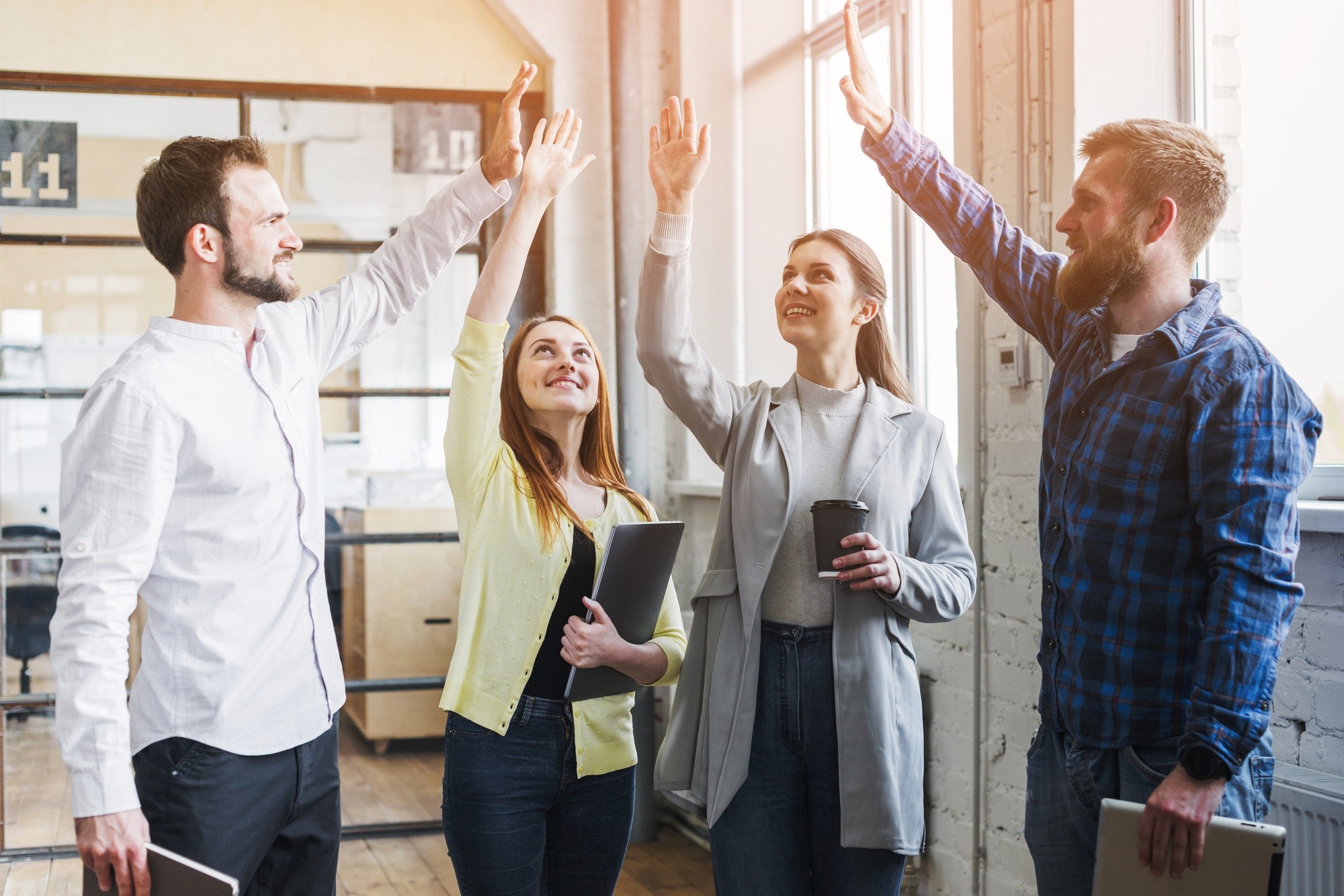 young-colleagues-giving-high-five-each-other